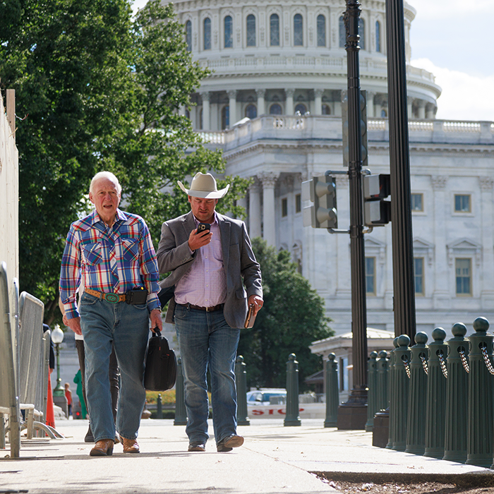 Members of various agricultural organizations walk between buildings on Capitol Hill in Washington, D.C. on September 28, 2022, as they lobby representatives for demands.