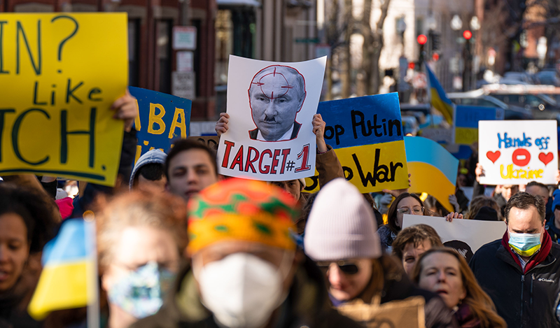 Protesters hold signs during a peaceful stand for Ukraine rally in Boston. Demonstrator came together in downtown Boston to protest against the increasing tension and violence following President Vladimir Putin's attack days prior.